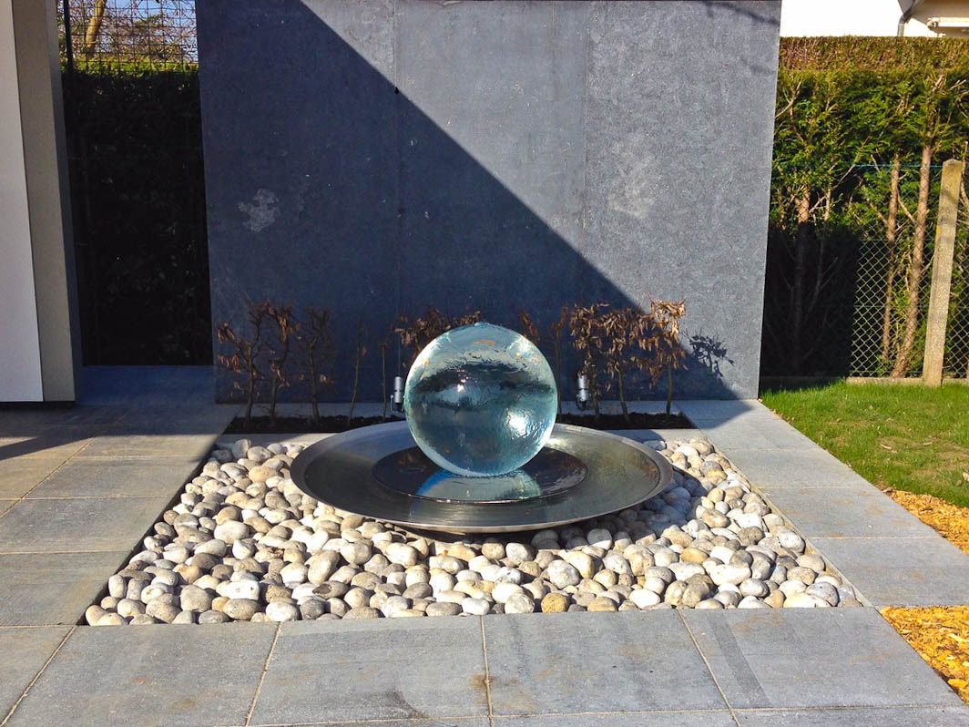 Fountain in garden near wall